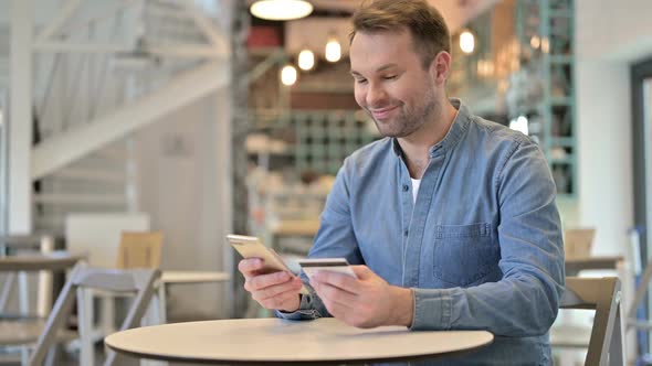 Casual Man Making Successful Online Payment on Smartphone