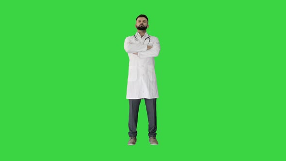 Successful Doctor with Folded Hands on a Green Screen, Chroma Key.