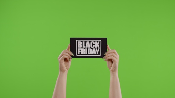 Black Friday Advertisement Inscription on Paper Sheet in Womans Hands on Chroma Key. Slow Motion
