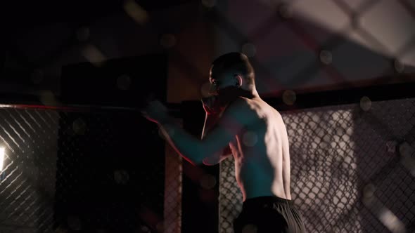 MMA Fighter Man Trains with Kickboxing in the Gym