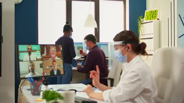 Businesswoman Talking on Video Call Wearing Protection Mask