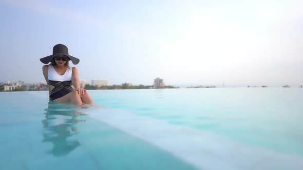 Young asian woman enjoy around outdoor swimming pool for leisure