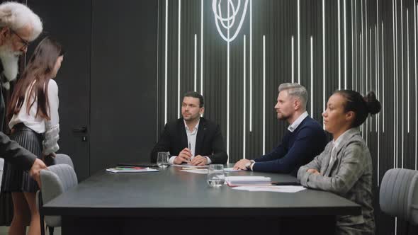 Man and Woman Join Business Meeting Greeting By Shaking Hands