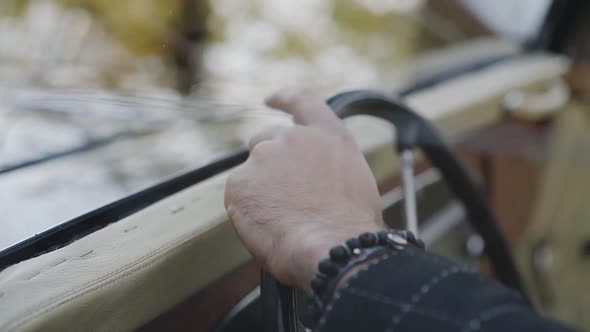 View of Male Fingers Knocking on Handlebar in Retro Car