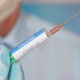 Close up of a researcher with face mask holding a syringe with coronavirus vaccine - VideoHive Item for Sale