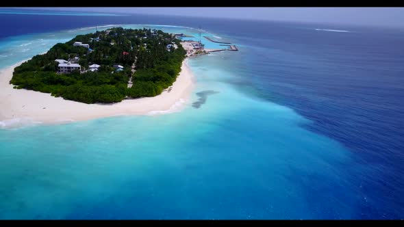 Aerial drone view scenery of idyllic shore beach adventure by blue green sea with white sand backgro