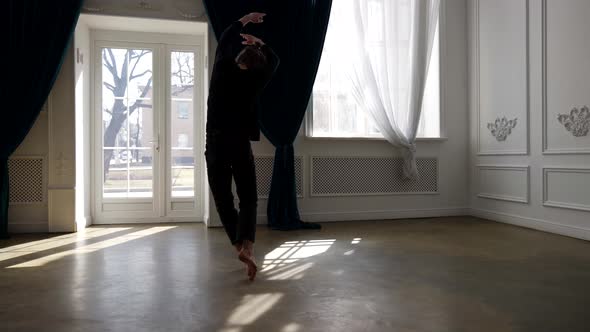 Young Man is Rehearsing in Dance Hall Alone Practicing Contemporary Choreography