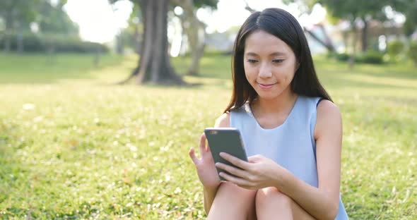 Woman use of smart phone in the park