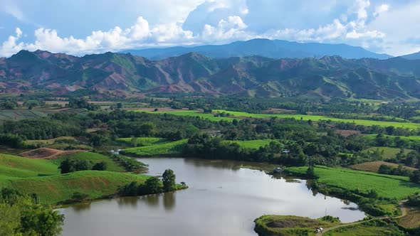 Aerial Orbit shot of a lake with mountains as background