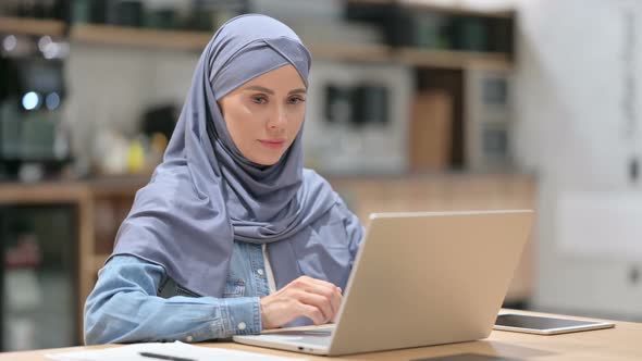 Positive Arab Woman with Laptop Showing Thumbs Up