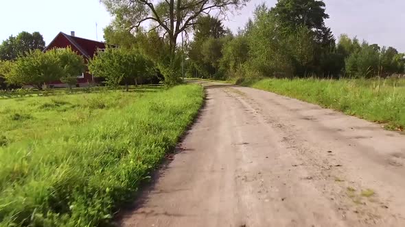 Movement on A Dirt Winding Road Gradually Turns in The Road with Improved Surface