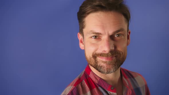 Attractive Sexy Caucasian Man Smiling Isolated on the Blue Background