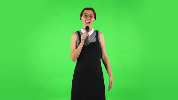 Funny Girl in Round Glasses Is Singing Into a Microphone and Moving To the Beat of Music. Green