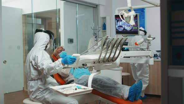 Dentist Technician in Coverall Preparing for Dental Surgery