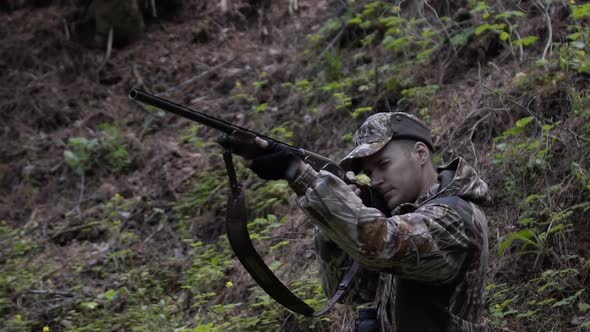 Man Hunter Takes Aim with Rifle. Men Take Aim. Man in Comfortable Camouflage Clothes Hunter Outdoor