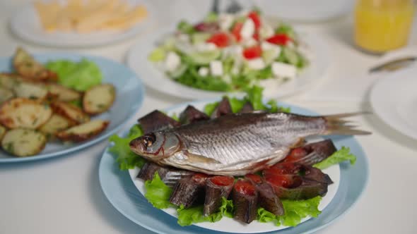 Healthy Lunch Sea Fish Cut Into Pieces with Caviar on White Plate Stands Background of Dishes During