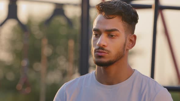 Young Attractive Arabic Male Student of Sports University or Coach Looks Pensively Aside Chooses