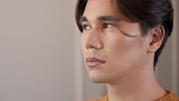 Makeup Studio - Makeup Artist Applying Dark Red Lip Pencil Over the Lip Contour of Male Model