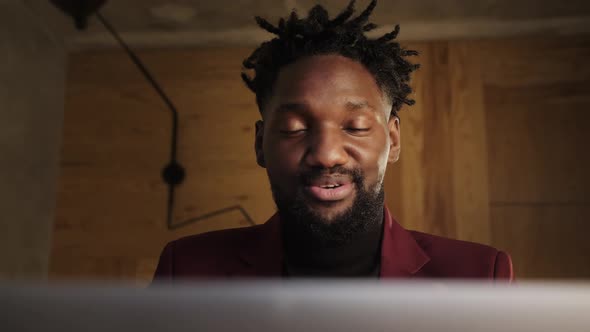 a Black Man Works at a Laptop Closeup of His Face