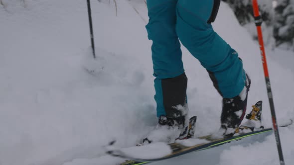 Man Ski Touring Through Snow Covered Forest