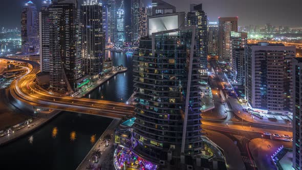 Aerial View of Dubai Marina Residential and Office Skyscrapers with Waterfront Night Timelapse