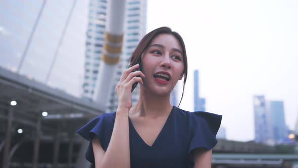 Happy Woman Walking and Talking Over Phone