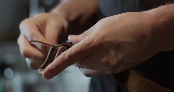 Craftsman Attaching Buckle to Belt