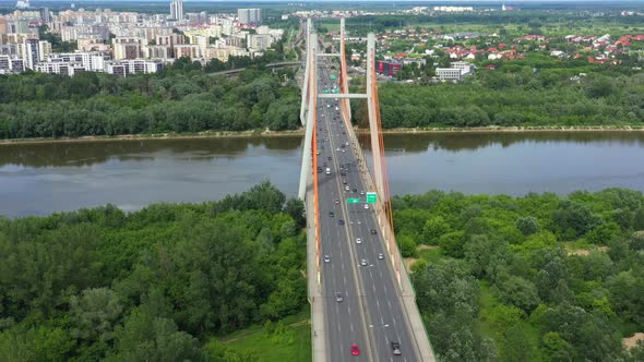 Car driving on highway bridge and road intersection in modern city aerial view