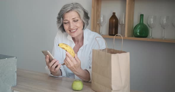 Mature Old Woman Received Food Delivered Home in a Grocery Bag
