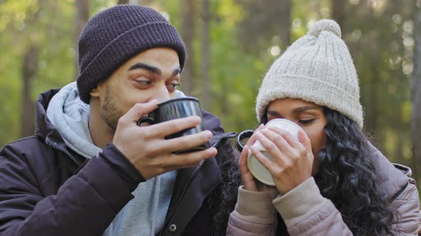 Closeup Young Married Couple Tourists Relaxing in Nature in Autumn Wood Warming with Hot Drink