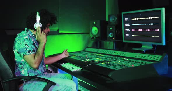 Sound male engineer mixing new album inside boutique recording studio