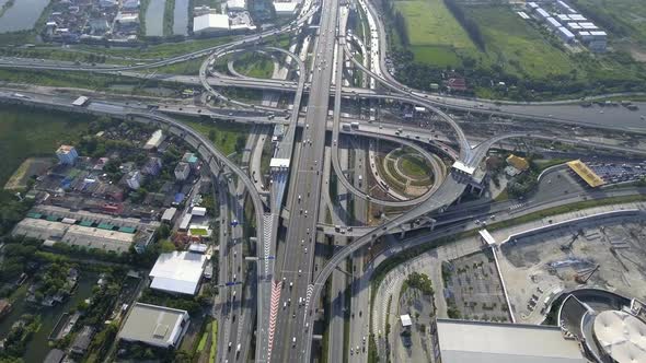 Aerial View of Highway Road Interchange with Busy Urban Traffic Speeding on Road