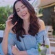 Pretty Brunette Woman Sitting in Outdoor Restaurant and Using Her Mobile Phone - VideoHive Item for Sale