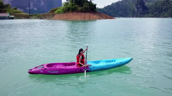 Cute Asian Girl Chilling Kayaking in Cheow Lan Lake Thailand