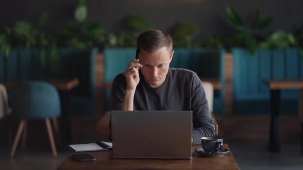 Thoughtful Serious Young Man Student Writer Sit at Home Office Desk with Laptop Thinking of