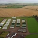 Drone Footage of Temporary Farm Workers' Housing Surrounded By Green Lawns - VideoHive Item for Sale