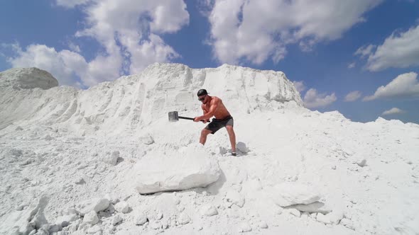 Man Hitting Stone With Hammer