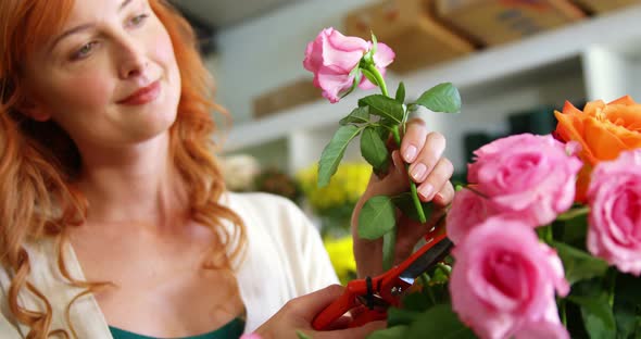 Female florist smelling flower