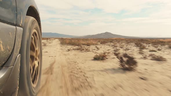 Wheels Spinning Straight Road On Deserted Gravel Terrain