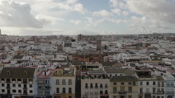 Flyover traditional Seville neighborhood toward St. Anne church in Triana District. Andalusia