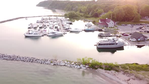 Yachts And Boats Anchored On The Harbor By The Lake Michigan In Leland, Michigan, USA During Sunrise