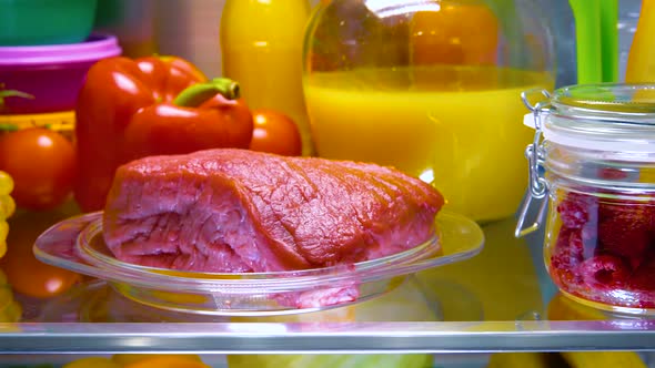 Fresh Raw Meat on a Shelf Open Refrigerator