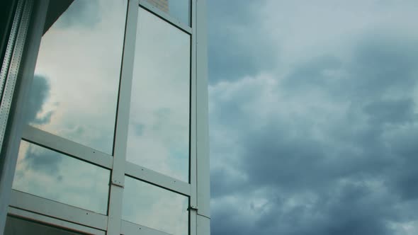 Timelapse of dramatic sky and as reflection on glass