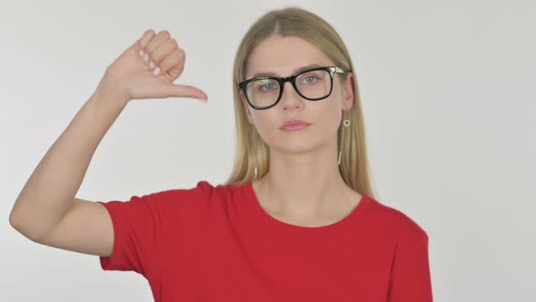 Thumbs Down by Young Woman on White Background