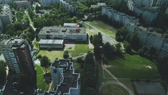 Tranquil Suburbs In A Big City. Multi Storey Buildings And A Large Green Area. An Old School Stadium