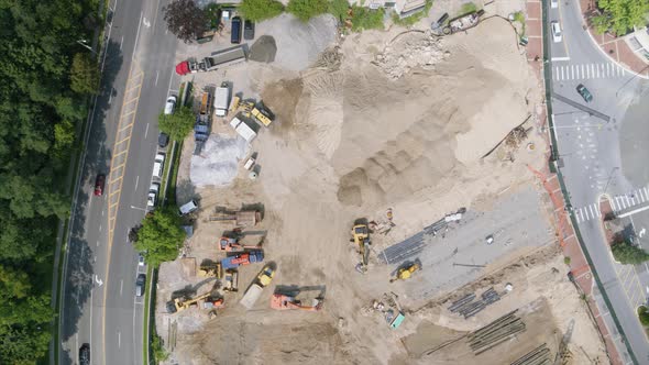 Top Down Aerial Panning Shot of a Construction Site by a Park