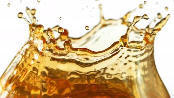 Super Slow Motion Shot of Brown Liquid Splash Isolated on White Background at 1000Fps