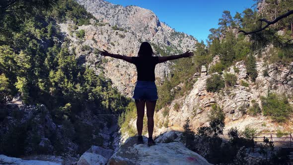 Fit woman athlete maintaining active healthy lifestyle, hiking on mountain range.