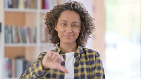 Portrait of Mixed Race Woman with Thumbs Down