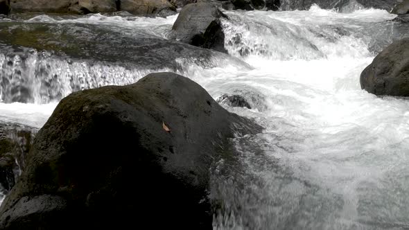 Slow Motion White Water Flowing Over Rocks